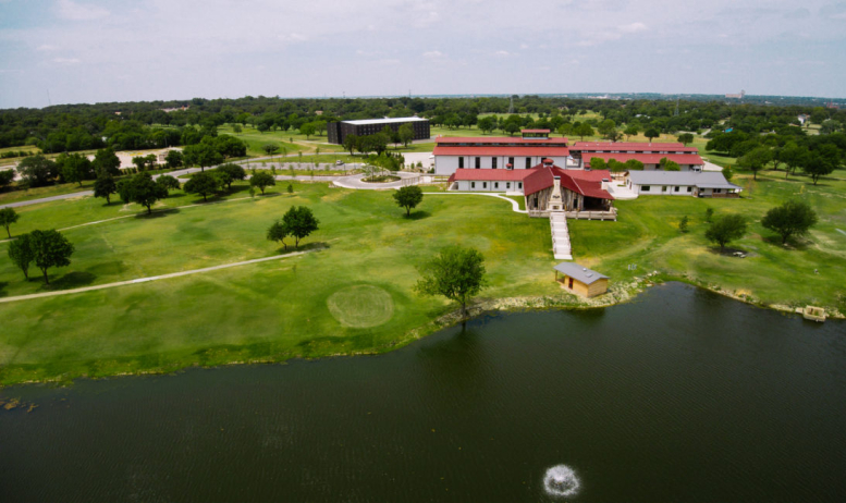 Beautiful aerial view of the TX Whiskey Ranch surrounded by greenery.